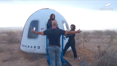 Jeff Bezos stands as Lauren Sanchez comes out of the capsule in which she, Pop star Katy Perry, journalist Gayle King, and other participants, landed back on earth after blasting off into space on a Blue Origin rocket, as part of the New Shepard Mission NS-31, marking the first all-female flight crew in more than six decades, in West Texas, Texas, U.S., April 14, 2025, in this screen grab taken from a video. Blue Origin/Handout via REUTERS (via REUTERS)