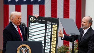 US President Donald Trump holds a chart next to US Secretary of Commerce Howard Lutnick as Trump delivers remarks on tariffs in the Rose Garden at the White House in Washington on April 2. (REUTERS)