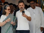 Rahul Gandhi and Sonia Gandhi take a selfie at a polling station during the sixth phase of the general election, in New Delhi.