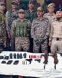 Security personnel with arms and ammunition recovered during a search operation in Kangpokpi district. (Manipur Police)