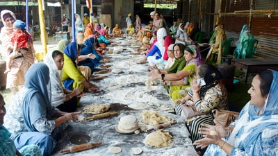 Women in a group knead dough and prepare chapatis on the occasion of Khalsa Sajna Diwas and Baisakhi, near Shahid Minar in Kolkata on Sunday. (HT photo) Women in a group knead dough and prepare chapatis on the occasion of Khalsa Sajna Diwas and Baisakhi, near Shahid Minar in Kolkata on Sunday. (HT photo)