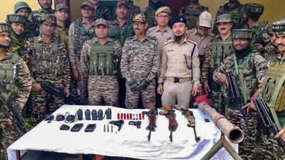 Security personnel with arms and ammunition recovered during a search operation in Kangpokpi district. (Manipur Police) Security personnel with arms and ammunition recovered during a search operation in Kangpokpi district. (Manipur Police)