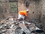 A man goes through the charred remains in a house at the violence-affected Samsergunj area, in Murshidabad on Tuesday. Following the violent protests against the Waqf (Amendment) Act 2025, the displaced families took refuge in adjoining Malda district. 