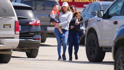 Superintendent Stephanie Elizalde, left center, spoke with a highway patrolman outside Wilmer-Hutchins High School. “We were in class,” Detaeja King told NBC5 while recalling the tragic shooting that left students shaken. “I heard like six shots and the teacher ran to the door and closed it and told us to hide in the corner,” added King, who is a junior at Wilmer-Hutchins. (AP Photo/Julio Cortez) (AP) Superintendent Stephanie Elizalde, left center, spoke with a highway patrolman outside Wilmer-Hutchins High School. “We were in class,” Detaeja King told NBC5 while recalling the tragic shooting that left students shaken. “I heard like six shots and the teacher ran to the door and closed it and told us to hide in the corner,” added King, who is a junior at Wilmer-Hutchins. (AP Photo/Julio Cortez) (AP)