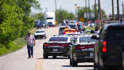 An undercover Texas Highway patrolman arrived to Wilmer-Hutchins High School. (AP Photo/Julio Cortez) (AP) An undercover Texas Highway patrolman arrived to Wilmer-Hutchins High School. (AP Photo/Julio Cortez) (AP)