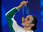 Gold medalist Algeria's Imane Khelif kisses her medal for the women's 66 kg final boxing match at the 2024 Summer Olympics, Friday, Aug. 9, 2024, in Paris, France. (AP Photo/John Locher, file)