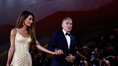 George Clooney and Amal Clooney walk on the red carpet during arrivals for the movie 'Wolfs'. (REUTERS)