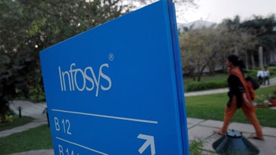 FILE PHOTO: An employees walks past a signage board in the Infosys campus at the Electronics City IT district in Bangalore, February 28, 2012. (REUTERS)
