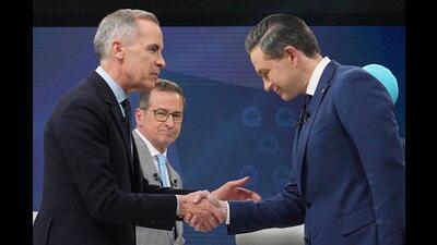 Liberal Leader Mark Carney shakes hands with Conservative Leader Pierre Poilievre following the French-language federal leaders' debate, in Montreal, on Wednesday. (REUTERS)