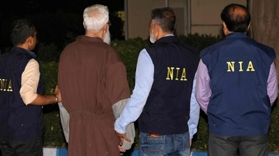 National Investigation Agency (NIA) officials along with Tahawwur Hussain Rana. (AFP file photo)