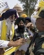 BSF personnel stop Shiromani Akali Dal (Amritsar) president Simranjit Singh Mann and his supporters during a protest march demanding opening of borders for trade between India and Pakistan, at Attari border, on Thursday. (PTI) BSF personnel stop Shiromani Akali Dal (Amritsar) president Simranjit Singh Mann and his supporters during a protest march demanding opening of borders for trade between India and Pakistan, at Attari border, on Thursday. (PTI)