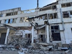 Rescuers work at the site where a bakery was hit by a Russian drone strike, amid Russia's attack on Ukraine, in Sumy, Ukraine April 18, 2025.
