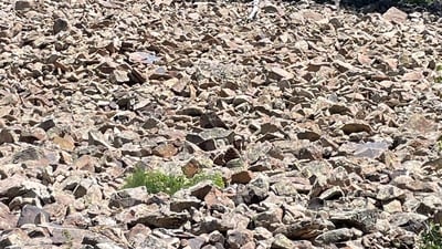 Can you spot the woman camouflaged in a rocky landscape? (Reddit/Warm_Concentrate0420) Can you spot the woman camouflaged in a rocky landscape? (Reddit/Warm_Concentrate0420)