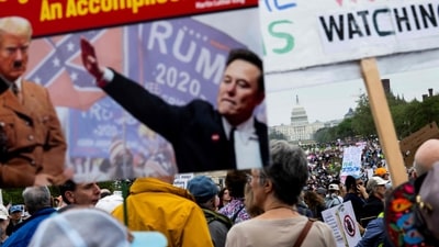 Protesters gather on the National Mall for the nationwide "Hands Off!" protest against US President Donald Trump and his advisor, Tesla CEO Elon Musk, in Washington. (AFP) Protesters gather on the National Mall for the nationwide "Hands Off!" protest against US President Donald Trump and his advisor, Tesla CEO Elon Musk, in Washington. (AFP)