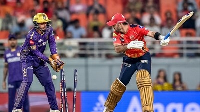 Punjab Kings' Glenn Maxwell (R) is clean bowled by Kolkata Knight Riders' Varun Chakravarthy (AFP)