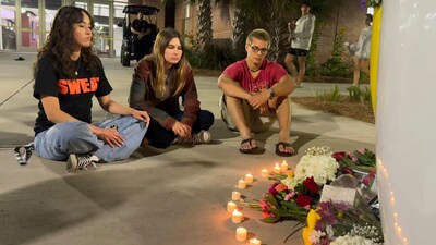 People sit in front of a makeshift memorial outside the student union at Florida State University, Thursday, April 17, 2025, in Tallahassee. (AP) People sit in front of a makeshift memorial outside the student union at Florida State University, Thursday, April 17, 2025, in Tallahassee. (AP)