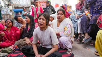 Relatives grieve after a 17-year-old boy was stabbed to death in Delhi's Seelampur area. (PTI) Relatives grieve after a 17-year-old boy was stabbed to death in Delhi's Seelampur area. (PTI)