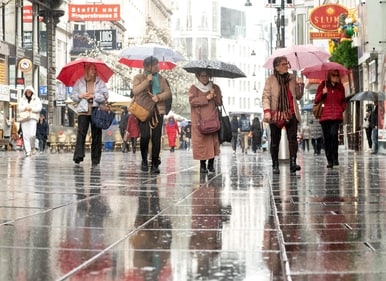 People walk under the rain in the 'Kaertner strasse' shopping street in Vienna, Austria, on March 31, 2025. (Photo by JOE KLAMAR / AFP) (AFP) People walk under the rain in the 'Kaertner strasse' shopping street in Vienna, Austria, on March 31, 2025. (Photo by JOE KLAMAR / AFP) (AFP)