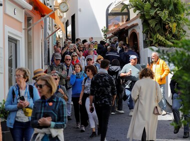 People walk in the street on Capri Island, Italy. European holiday hotspot Capri becomes dormitory for tourists amid mass tourism in Italy (Photo by REUTERS/Ciro De Luca)