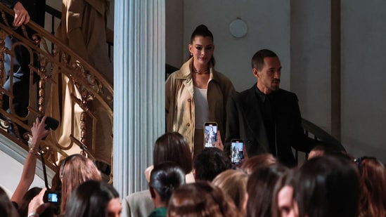 Celebrities like Anne Hathaway attended the show, dressed in a pair of cream-colored jeans entirely embroidered with sequins and purposefully shredded at the thighs, knees and shins. She styled the pants with a tan trench coat, white tank and super-sleek ponytail.&nbsp;(REUTERS)