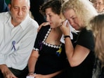 Aren Almon, center, whose daughter Baylee became a national symbol in an iconic photo of a firefighter holding her lifeless body following the bombing of the federal building in Oklahoma City, is comforted by her father Tommy Almon and mother Debbie Almon, during a funeral service for Baylee at Arlington Memorial Park Cemetery in Oklahoma City, April 24, 1995. (AP Photo/Pat Sullivan, File)
