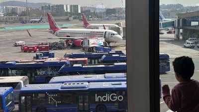 A boy looks at Air India airline passenger aircraft parked at the Chhatrapati Shivaji Maharaj International Airport in Mumbai. (Reuters)
