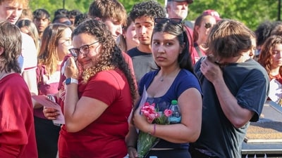 The day after an active shooter on campus, Florida State students place electronic candles on a platform during a vigil on campus at Langford Green, Tallahassee, Fla., Friday, April 18, 2025. (AP) The day after an active shooter on campus, Florida State students place electronic candles on a platform during a vigil on campus at Langford Green, Tallahassee, Fla., Friday, April 18, 2025. (AP)