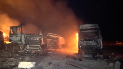 Fire and smoke rise next to charred vehicles following, what Al Masirah TV said, was a U.S. strike on the Ras Isa fuel port, Yemen, in this screengrab from a handout video released on April 18, 2025. (Reuters)