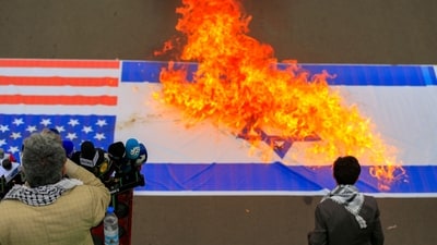 Demonstrators burn US and Israeli flags during a rally in solidarity with Palestinians in the Gaza Strip and in condemnation of US strikes, in Yemen's Huthi-controlled capital Sanaa on April 18, 2025. US strikes on a Yemeni fuel port killed at least 74 people, Huthi rebels said on April 18, in the deadliest attack of Washington's 15-month campaign against the Iran-backed group. (Photo by Mohammed HUWAIS / AFP) (AFP) Demonstrators burn US and Israeli flags during a rally in solidarity with Palestinians in the Gaza Strip and in condemnation of US strikes, in Yemen's Huthi-controlled capital Sanaa on April 18, 2025. US strikes on a Yemeni fuel port killed at least 74 people, Huthi rebels said on April 18, in the deadliest attack of Washington's 15-month campaign against the Iran-backed group. (Photo by Mohammed HUWAIS / AFP) (AFP)