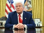 US President Donald Trump looks on after signing an executive order in the Oval Office of the White House.
