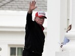 U.S. President Donald Trump gestures while wearing a hat that reads "Gulf of America"