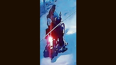 A CCTV grab of the bike-borne suspects who opened fire at the residence of gangster Puneet Bains on Sunday in Ludhiana. (HT Photo)