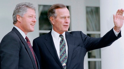 President George H. Bush waves as Bill Clinton stands alongside in 1992 (AP) President George H. Bush waves as Bill Clinton stands alongside in 1992 (AP)