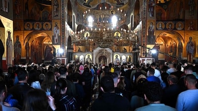 Orthodox Christians take part in the Easter service at the Cathedral in Podgorica, Montenegro, on April 20, 2025. (Photo by SAVO PRELEVIC / AFP) (AFP) Orthodox Christians take part in the Easter service at the Cathedral in Podgorica, Montenegro, on April 20, 2025. (Photo by SAVO PRELEVIC / AFP) (AFP)