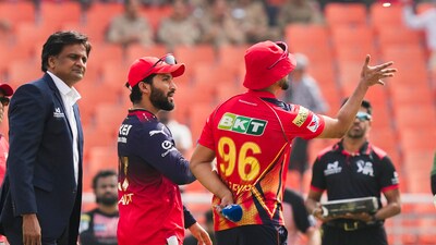 Punjab Kings captain Shreyas Iyer flips the coin as Royal Challengers Bengaluru captain Rajat Patidar calls. Patidar won the toss and opted to bowl first in Mullanpur. (PTI) Punjab Kings captain Shreyas Iyer flips the coin as Royal Challengers Bengaluru captain Rajat Patidar calls. Patidar won the toss and opted to bowl first in Mullanpur. (PTI)