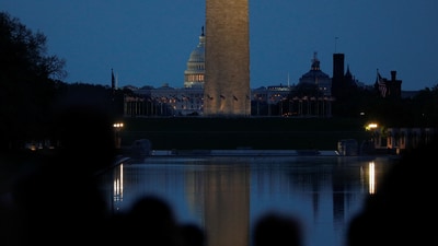 The U.S. Capitol and Washington Monument are visible just before dawn as people await the beginning of an Easter sunrise service at the Lincoln Memorial, a tradition for more than 40 years, in Washington, D.C., U.S., April 20, 2025. REUTERS/Allison Bailey (REUTERS)