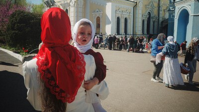 A mother carries her daughter during the celebration of Orthodox Easter at Cross Lower Church of the Ukrainian Orthodox Church in Kharkiv, Ukraine, on Sunday, April 20, 2025. (AP Photo/George Ivanchenko) (AP) A mother carries her daughter during the celebration of Orthodox Easter at Cross Lower Church of the Ukrainian Orthodox Church in Kharkiv, Ukraine, on Sunday, April 20, 2025. (AP Photo/George Ivanchenko) (AP)