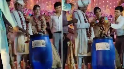 A group of wedding guests gifted the blue drum to the bride and groom and filmed a video. (X/ @Info_4Education) A group of wedding guests gifted the blue drum to the bride and groom and filmed a video. (X/ @Info_4Education)