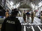 U.S. military personnel escort alleged members of the Venezuelan gang Tren de Aragua and the MS-13 gang recently deported by the U.S. government to be imprisoned in the Terrorism Confinement Center (CECOT) prison, at the El Salvador International Airport in San Luis Talpa, El Salvador April 12, 2025.