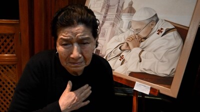 A faithful Catholic reacts while praying in front of a painting depicting Pope Francis at the Basilica San Jose de Flores in Buenos Aires on April 21, 2025, following the death of Pope Francis in the Vatican. The Basilica de San Jose de Flores was the church where Pope Francis was inspired to consecrate his life to God and the Catholic Church. Pope Francis died on April 21, 2025 aged 88, a day after making a much hoped-for appearance at Saint Peter's Square on Easter Sunday, the Vatican said in a statement. (Photo by Luis ROBAYO / AFP) (AFP) A faithful Catholic reacts while praying in front of a painting depicting Pope Francis at the Basilica San Jose de Flores in Buenos Aires on April 21, 2025, following the death of Pope Francis in the Vatican. The Basilica de San Jose de Flores was the church where Pope Francis was inspired to consecrate his life to God and the Catholic Church. Pope Francis died on April 21, 2025 aged 88, a day after making a much hoped-for appearance at Saint Peter's Square on Easter Sunday, the Vatican said in a statement. (Photo by Luis ROBAYO / AFP) (AFP)