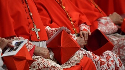 (FILES) Cardinals hold their berretta square cap (Biretta) on their knee as they attend a Pope's Ordinary Public Consistory for the creation of new cardinals, for the imposition of the biretta, the consignment of the ring and the assignment of the Title or Diaconate, on October 5, 2019 at St. Peter's Basilica in the Vatican. The death of Pope Francis on April 21, 2025 sets in motion centuries-old traditions which will culminate in the election by cardinals of a new pontiff. Under a system originating in the 13th century, the conclave sees cardinals aged under 80 meet in private to choose the next pope from among their peers. They are sworn to absolute secrecy, under pain of ex-communication, during the voting. (Photo by Tiziana FABI / AFP) (AFP) (FILES) Cardinals hold their berretta square cap (Biretta) on their knee as they attend a Pope's Ordinary Public Consistory for the creation of new cardinals, for the imposition of the biretta, the consignment of the ring and the assignment of the Title or Diaconate, on October 5, 2019 at St. Peter's Basilica in the Vatican. The death of Pope Francis on April 21, 2025 sets in motion centuries-old traditions which will culminate in the election by cardinals of a new pontiff. Under a system originating in the 13th century, the conclave sees cardinals aged under 80 meet in private to choose the next pope from among their peers. They are sworn to absolute secrecy, under pain of ex-communication, during the voting. (Photo by Tiziana FABI / AFP) (AFP)