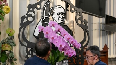 A portrait of Pope Francis (C) is seen as church officials make preparations at the Jakarta Cathedral in Jakarta on April 21, 2025, following the death of Pope Francis in the Vatican (Photo by BAY ISMOYO / AFP) (AFP) A portrait of Pope Francis (C) is seen as church officials make preparations at the Jakarta Cathedral in Jakarta on April 21, 2025, following the death of Pope Francis in the Vatican (Photo by BAY ISMOYO / AFP) (AFP)