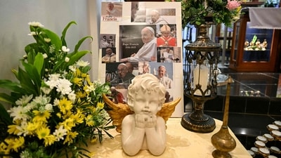 Portraits of Pope Francis are displayed ahead of a mass following his death at Sacred Heart Church in Bentong, on April 21, 2025. Pope Francis died on April 21, 2025 aged 88, a day after making a much hoped-for appearance at Saint Peter's Square on Easter Sunday, the Vatican said in a statement. (Photo by MOHD RASFAN / AFP) (AFP) Portraits of Pope Francis are displayed ahead of a mass following his death at Sacred Heart Church in Bentong, on April 21, 2025. Pope Francis died on April 21, 2025 aged 88, a day after making a much hoped-for appearance at Saint Peter's Square on Easter Sunday, the Vatican said in a statement. (Photo by MOHD RASFAN / AFP) (AFP)