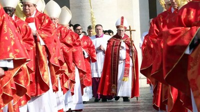 Pope Francis, flanked by cardinals, arrives in procession at St. Peter's Square during the Palm Sunday Mass on March 25, 2018, in Vatican City. Franco Origlia/Getty Images 