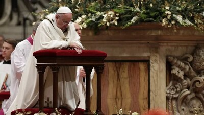 Francis kneels as he leads the Christmas Eve mass in St. Peter's Basilica at the Vatican on December 24, 2014. Max Rossi/Reuters 