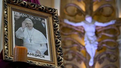 A portrait of the late Pope Francis sits at Moscow's Cathedral of Virgin Mary Immaculate Conception on April 21, 2025. (Photo by Alexander NEMENOV / AFP) (AFP) A portrait of the late Pope Francis sits at Moscow's Cathedral of Virgin Mary Immaculate Conception on April 21, 2025. (Photo by Alexander NEMENOV / AFP) (AFP)