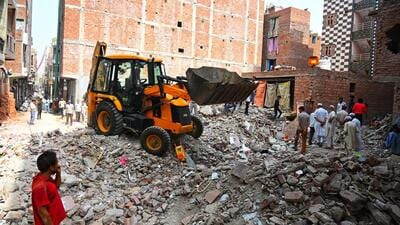 Residents around the debris in Mustafabad on Monday. (Vipin Kumar/HT Photoimes)