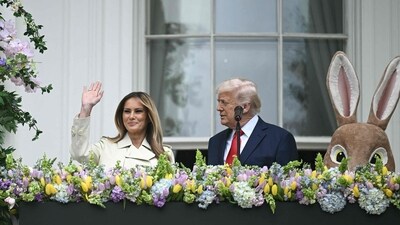 US President Donald Trump and First Lady Melania Trump address the crowd from the Blue Room Balcony as they host the annual Easter Egg Roll on the South Lawn of the White House on April 21, 2025, in Washington, DC. According to the US National Park Service, the egg roll tradition dates back to 1878 when President Rutherford B. Hayes invited children to roll Easter eggs on the White House grounds. Children previously rolled eggs down a hill at the US Capitol in the early 1870s, but a law was passed in 1876 forbidding the Capitol property from being used due to the toll on the lawn. (Photo by Brendan SMIALOWSKI / AFP) (AFP) US President Donald Trump and First Lady Melania Trump address the crowd from the Blue Room Balcony as they host the annual Easter Egg Roll on the South Lawn of the White House on April 21, 2025, in Washington, DC. According to the US National Park Service, the egg roll tradition dates back to 1878 when President Rutherford B. Hayes invited children to roll Easter eggs on the White House grounds. Children previously rolled eggs down a hill at the US Capitol in the early 1870s, but a law was passed in 1876 forbidding the Capitol property from being used due to the toll on the lawn. (Photo by Brendan SMIALOWSKI / AFP) (AFP)