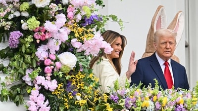 US President Donald Trump and First Lady Melania Trump address the crowd from the Blue Room Balcony as they host the annual Easter Egg Roll on the South Lawn of the White House on April 21, 2025, in Washington, DC. According to the US National Park Service, the egg roll tradition dates back to 1878 when President Rutherford B. Hayes invited children to roll Easter eggs on the White House grounds. Children previously rolled eggs down a hill at the US Capitol in the early 1870s, but a law was passed in 1876 forbidding the Capitol property from being used due to the toll on the lawn. (Photo by Mandel NGAN / AFP) (AFP) US President Donald Trump and First Lady Melania Trump address the crowd from the Blue Room Balcony as they host the annual Easter Egg Roll on the South Lawn of the White House on April 21, 2025, in Washington, DC. According to the US National Park Service, the egg roll tradition dates back to 1878 when President Rutherford B. Hayes invited children to roll Easter eggs on the White House grounds. Children previously rolled eggs down a hill at the US Capitol in the early 1870s, but a law was passed in 1876 forbidding the Capitol property from being used due to the toll on the lawn. (Photo by Mandel NGAN / AFP) (AFP)