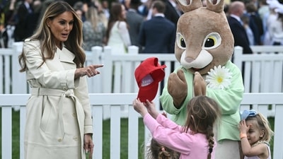 US First Lady Melania Trump reacts to a young girl holding a "Make America Great Again" hat during the annual Easter Egg Roll on the South Lawn of the White House on April 21, 2025, in Washington, DC. According to the US National Park Service, the egg roll tradition dates back to 1878 when President Rutherford B. Hayes invited children to roll Easter eggs on the White House grounds. Children previously rolled eggs down a hill at the US Capitol in the early 1870s, but a law was passed in 1876 forbidding the Capitol property from being used due to the toll on the lawn. (Photo by Brendan SMIALOWSKI / AFP) (AFP) US First Lady Melania Trump reacts to a young girl holding a "Make America Great Again" hat during the annual Easter Egg Roll on the South Lawn of the White House on April 21, 2025, in Washington, DC. According to the US National Park Service, the egg roll tradition dates back to 1878 when President Rutherford B. Hayes invited children to roll Easter eggs on the White House grounds. Children previously rolled eggs down a hill at the US Capitol in the early 1870s, but a law was passed in 1876 forbidding the Capitol property from being used due to the toll on the lawn. (Photo by Brendan SMIALOWSKI / AFP) (AFP)